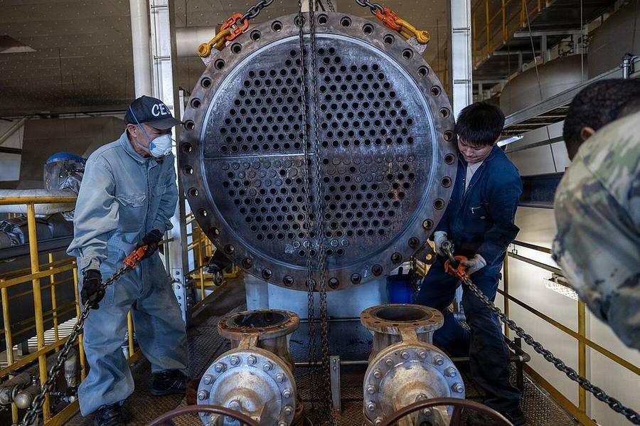 Crew servicing a commercial heat exchanger